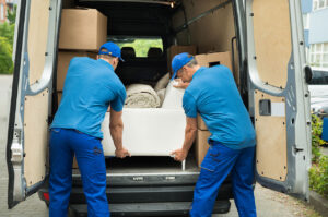 two men with a van demonstrating how to pack a van for moving