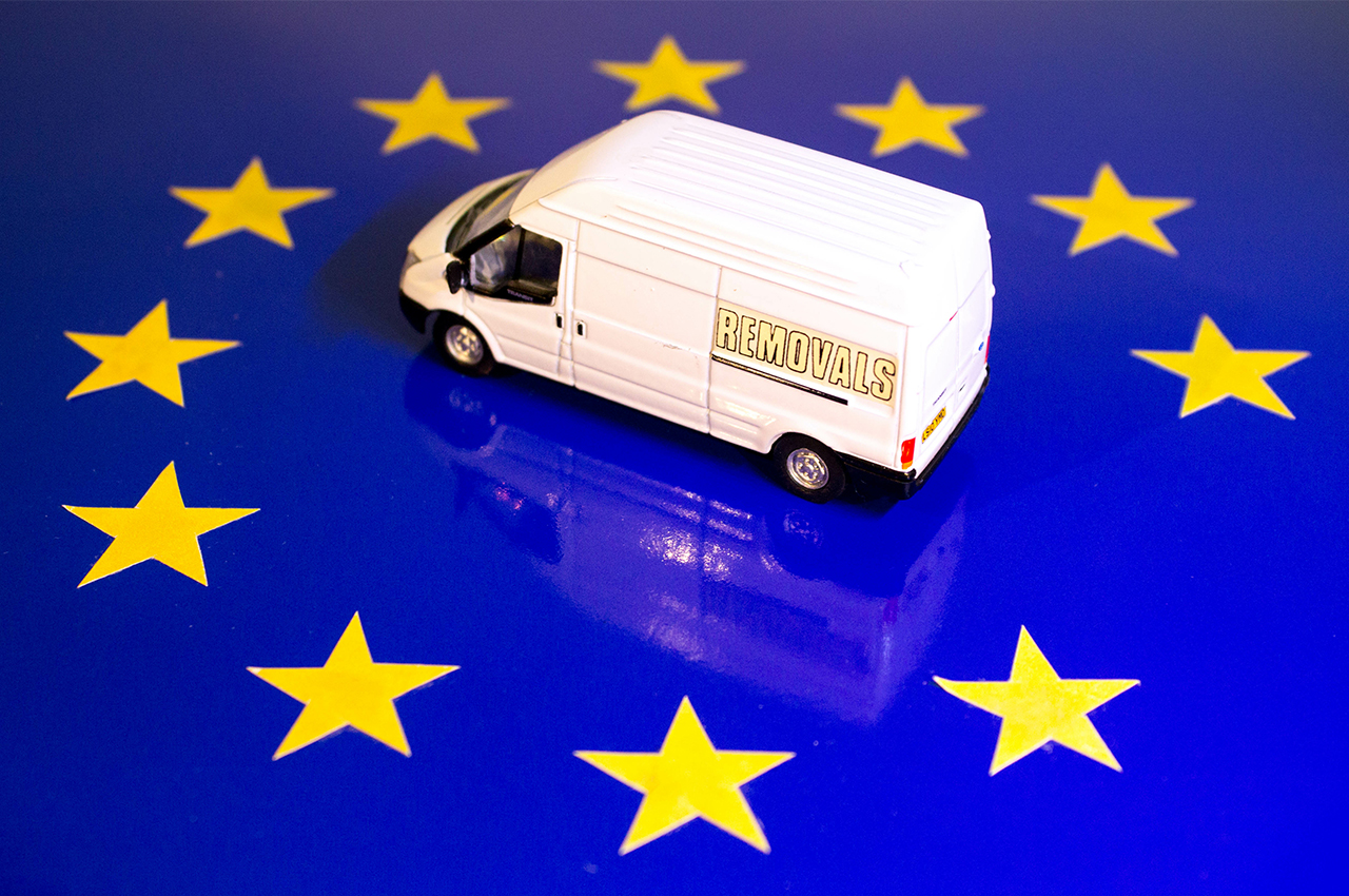 living in the eu after brexit concept with a moving van on an eu flag