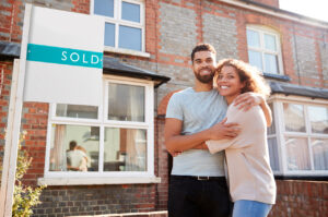 an embracing couple who have followed a thorough first-time buyers checklist